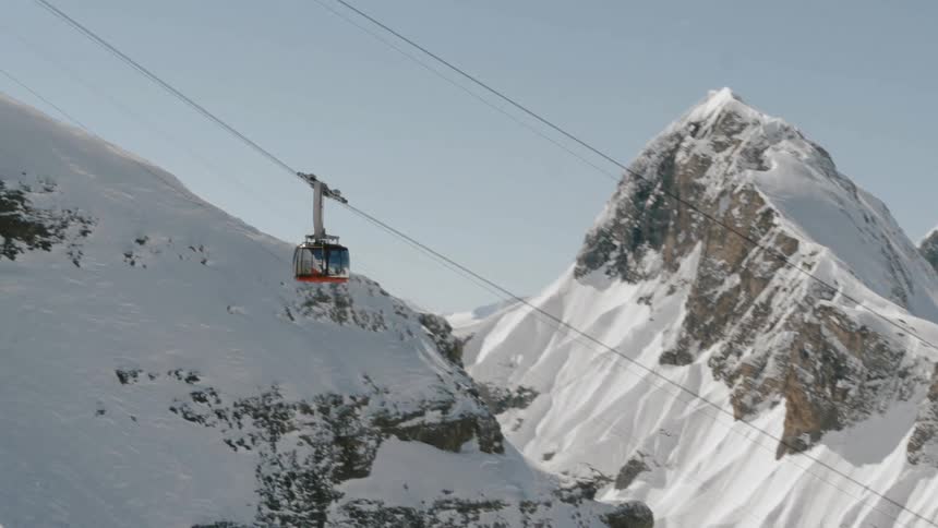 A gondola ascending a mountain