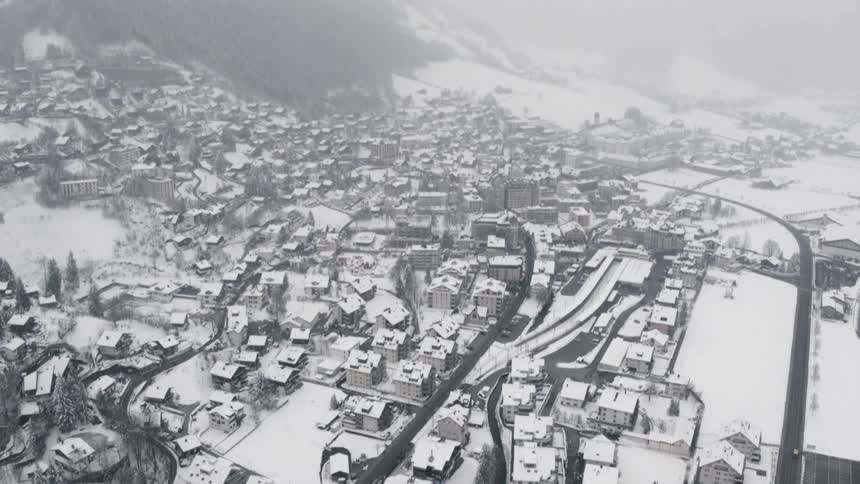 A snow covered town surrounded by mountains