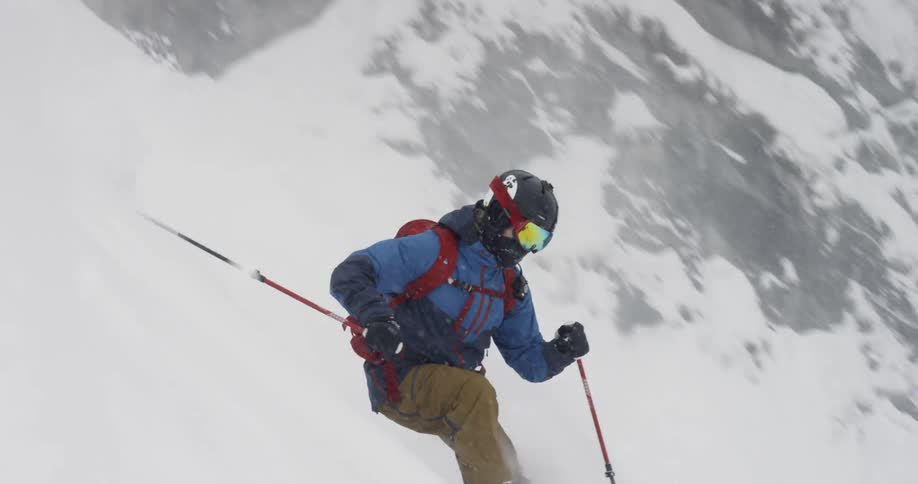 A person skiing down a snowy slope