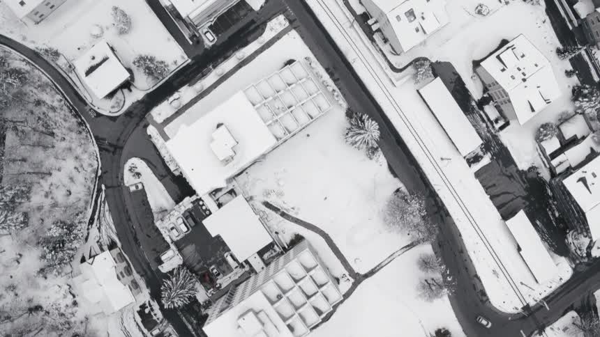 Camera flies over a town covered with snow