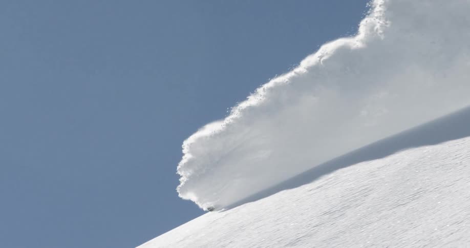 A person skis down a snow covered course