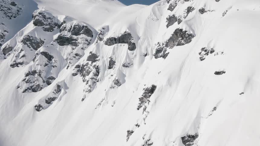 Aerial shot of a snowy cliff