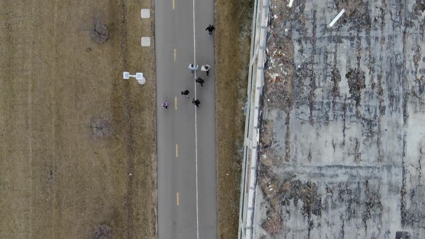 Aerial view of group of joggers walking down a street
