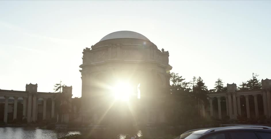 Sun streams through a classical rotunda surrounded by the portico at sunset