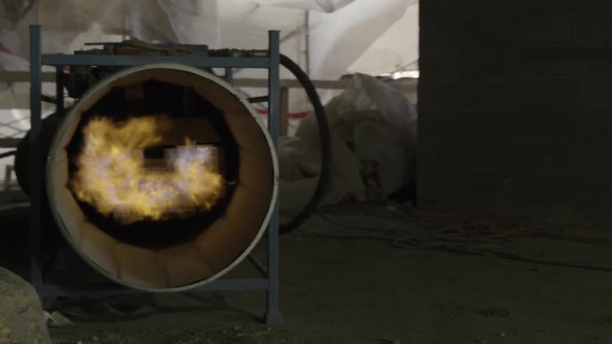 A jet engine on a metal mount shoots out fire