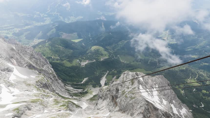 A cable car that is traveling up and down a mountain