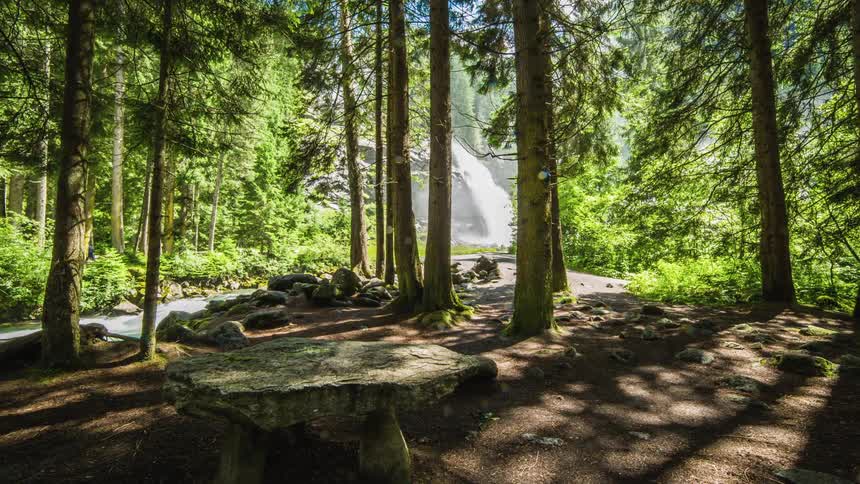 People hiking to a waterfall in the mountains