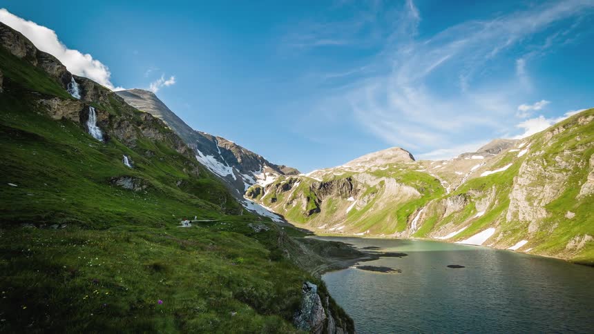Clouds float over river and mountains