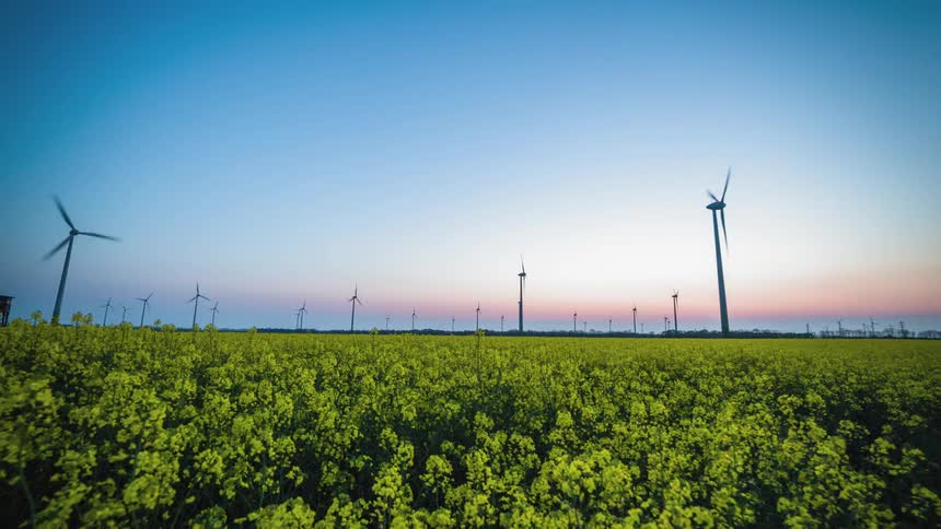 Static shot of windmills spinning in a timelapse