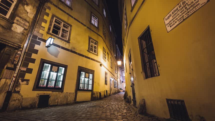 Timelapse of a narrow alley between buildings at night