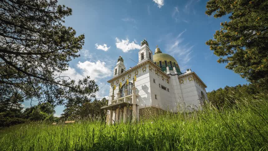 A castle sits in the field under a blue sky