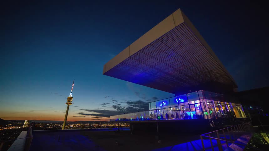 People walk around on the deck of a modern structure