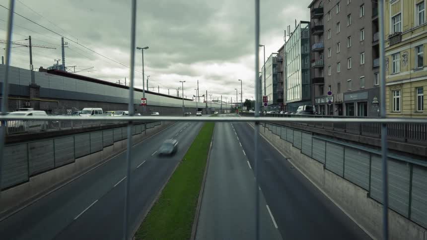 Cars and trucks move along busy city streets