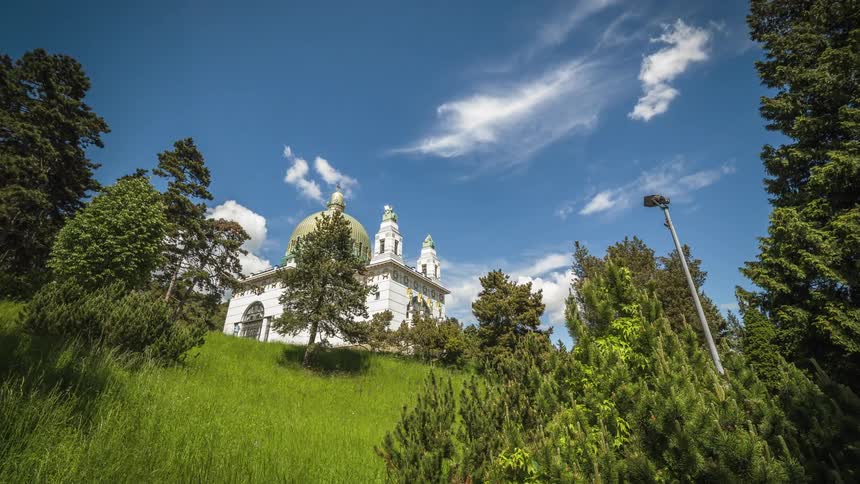 Timelapse of a wooded area with a large home at the top of a hill