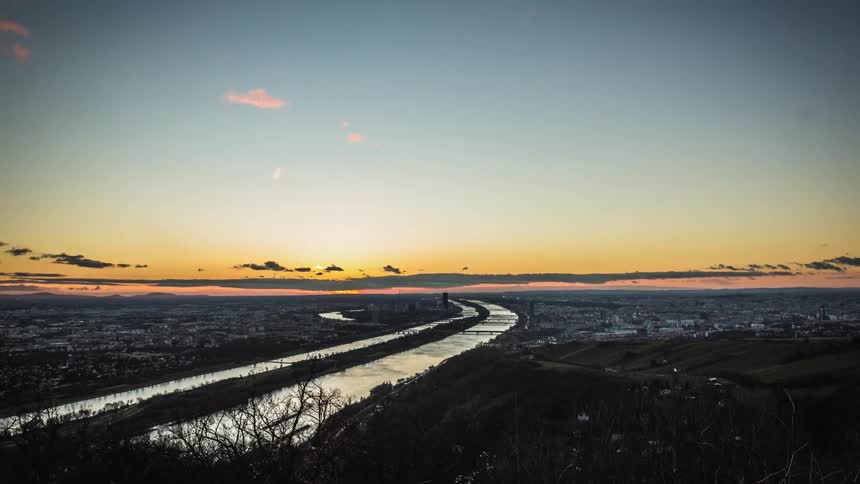 Clouds move over river and urban area