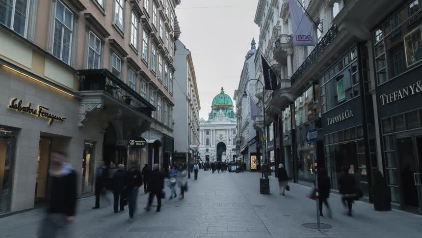 Time lapse of people walking down a city block with shopping