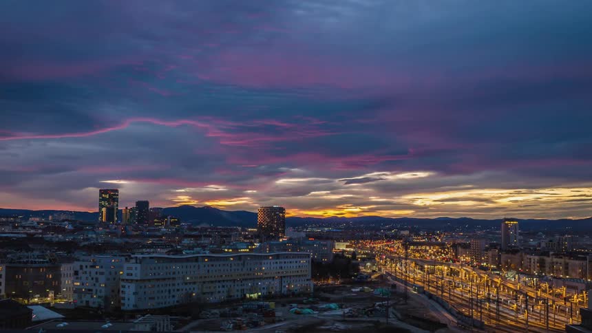 Sunset over a city center full of traffic and street lights