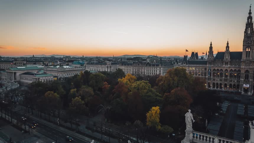 Sun sets and night falls over ornate historical buildings