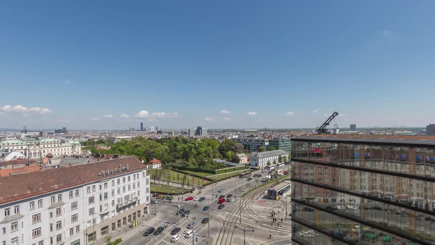 Cars travel on a busy city street on a clear summer day