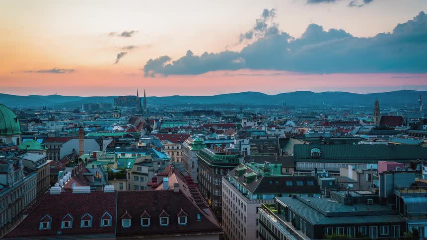 The rooftops of a city over the course of a day