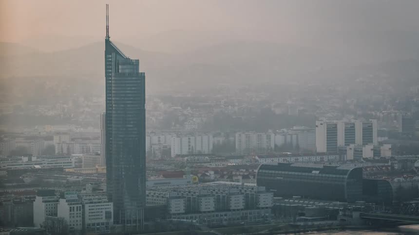 Fog covers downtown city obscuring mountains on horizon