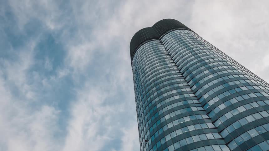 Time lapse of clouds going over a skyscraper