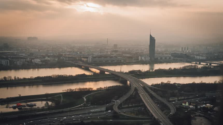 A time lapse of a busy road network and bridge which crosses a body of water