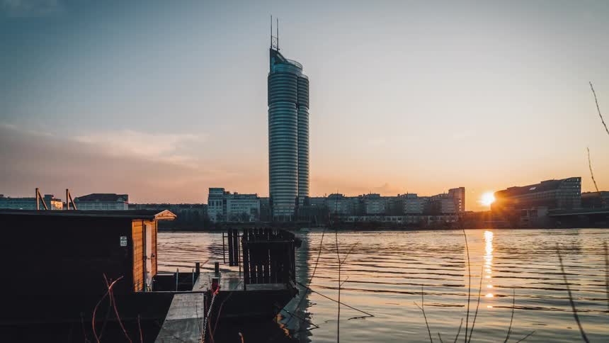 A skyscraper sits in the background of the river