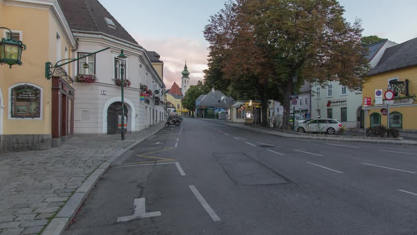 Cars move through the street in a small town