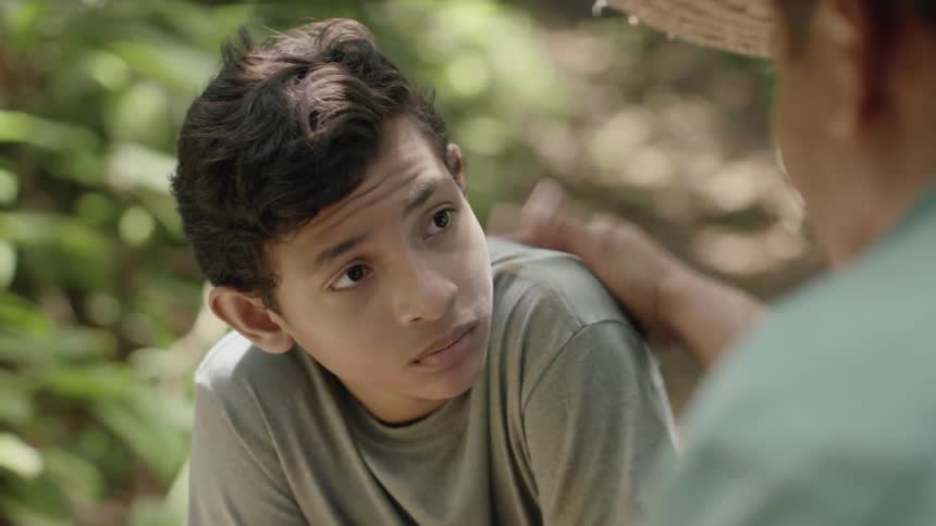A man and a boy have a discussion outside