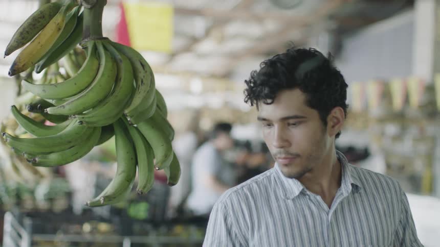 A man shopping in the produce section