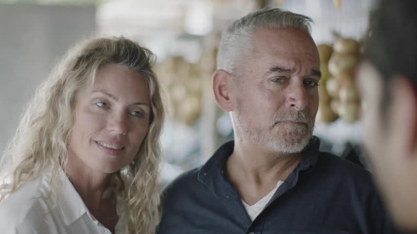 An man and woman talk with a younger man