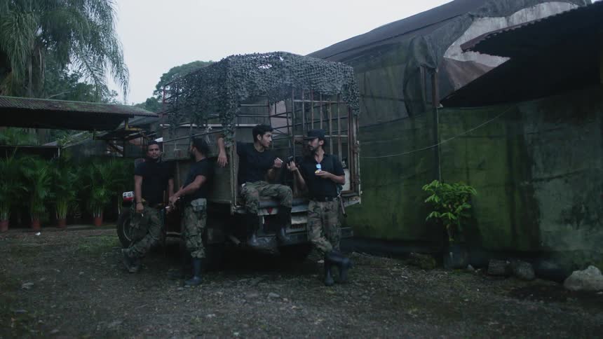 Military men relax near a truck