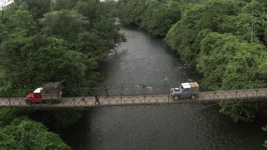 Jeep driving across bridge is stopped by armed men