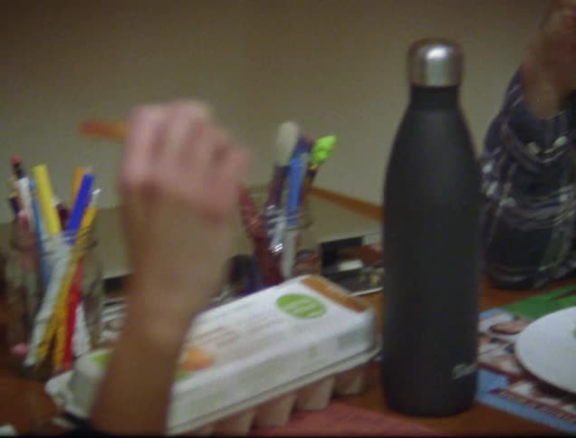A man and woman eating pizza at a table