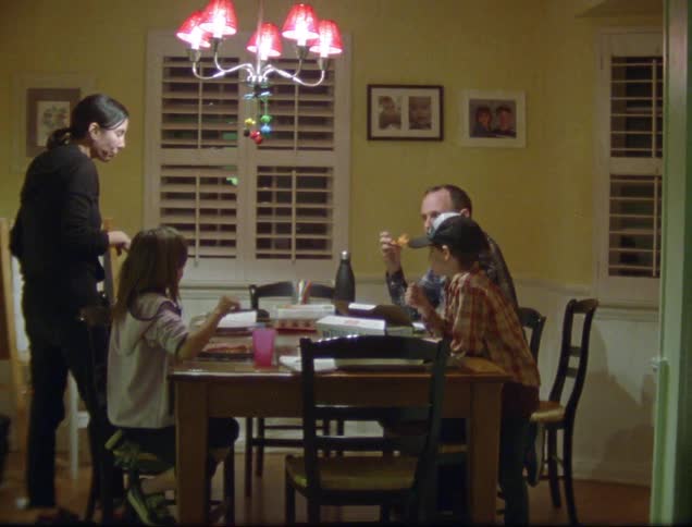 A family sits around a table eating