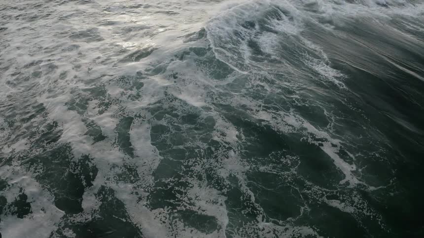 The waves roll in the ocean water