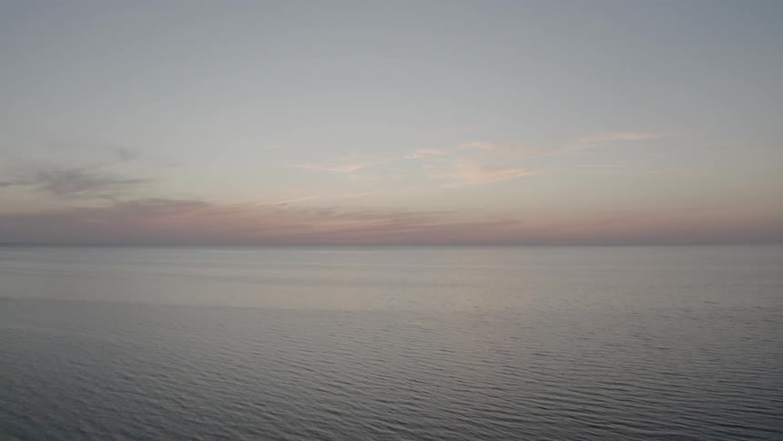 The sun sets in the horizon over the ocean