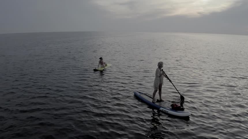 Two people on boards in the ocean