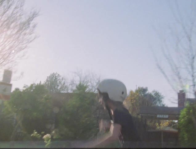 A young child skateboards through the street