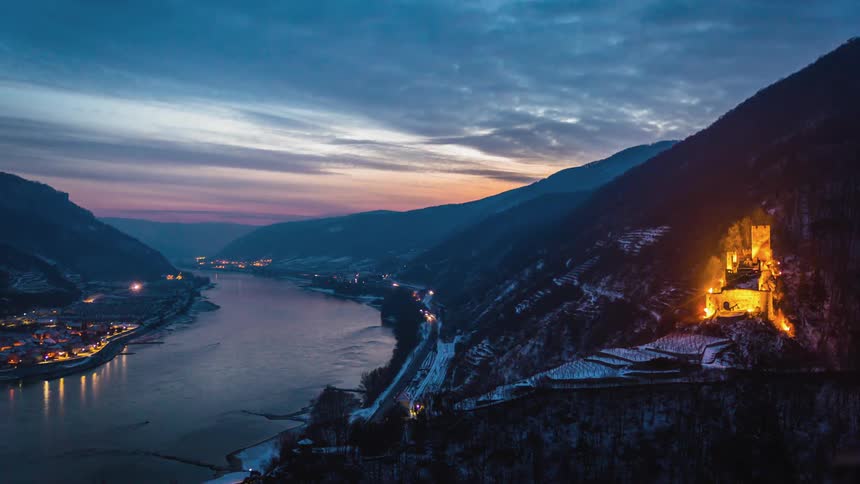 Road and river traffic between mountains and city