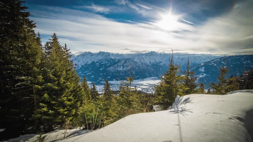 Clouds move over a snow covered mountain valley