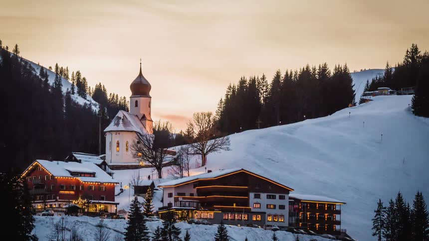 A building at the bottom of a snowy slope