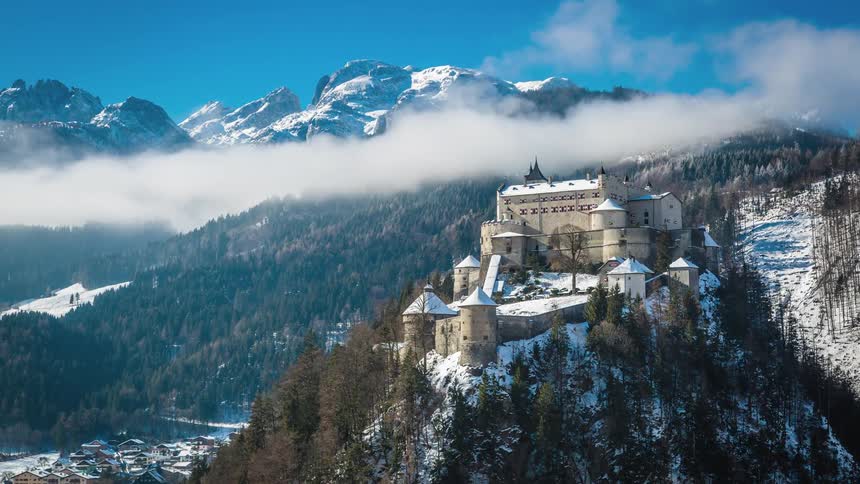 An old castle stands on a mountain top