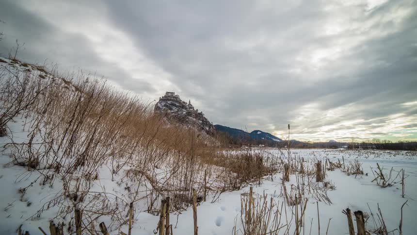 Gloomy clouds move over a snow covered plain