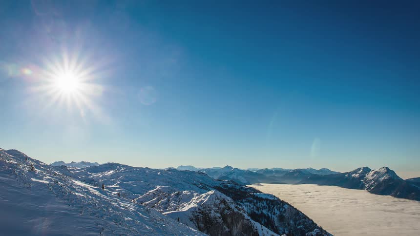 A plane flies over the mountains