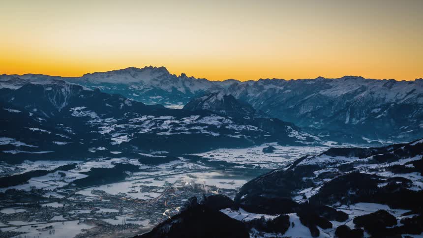 A hot spring creating steam in a snow covered rocky landscape