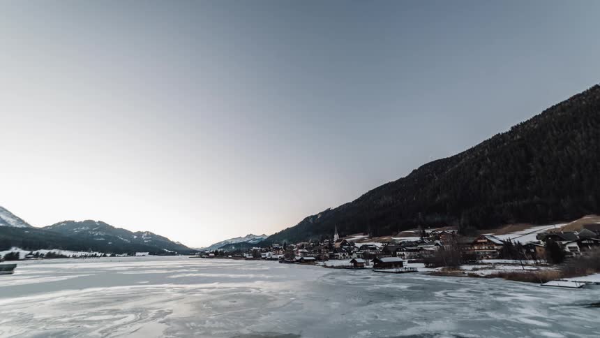 A small town sits on the bank of an iced up river