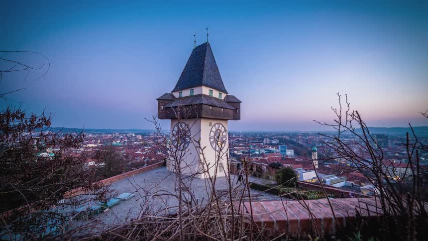 Time lapse view of people walking by a clock tower