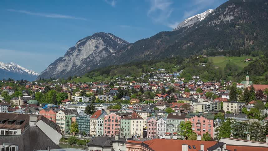 A town with mountains and the sky in the background
